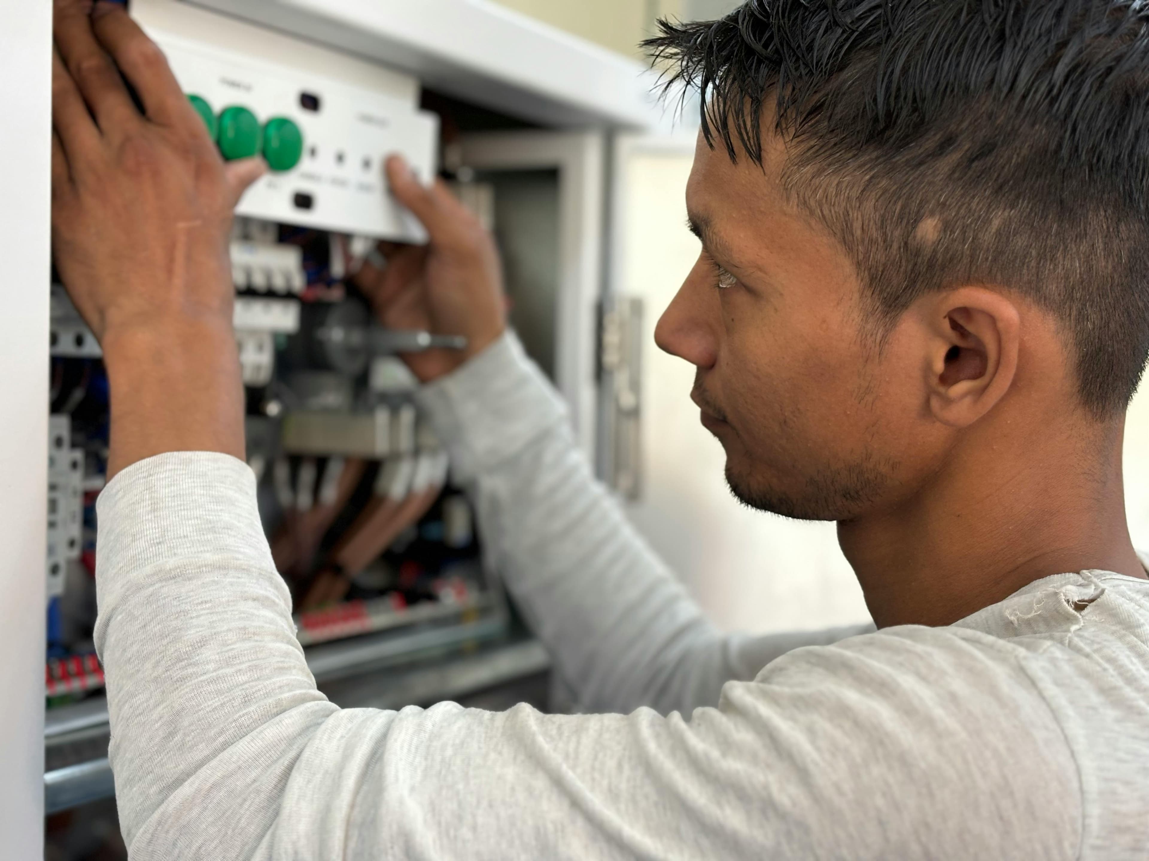Technician working on an electrical panel during an emergency call